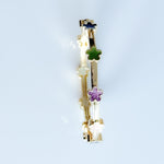 Gold bangle with floral designs on a light blue background