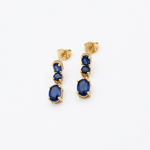 18K yellow gold natural blue sapphire dangle earrings with three sapphire stones in a graduated drop design.