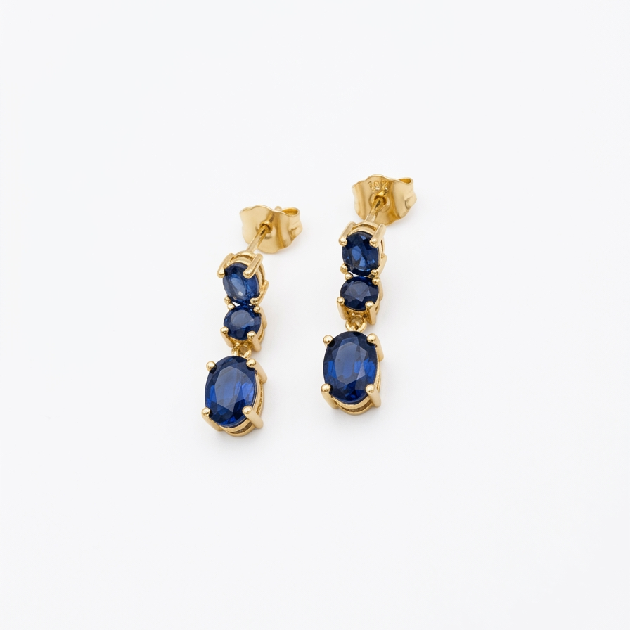 18K yellow gold natural blue sapphire dangle earrings with three sapphire stones in a graduated drop design.