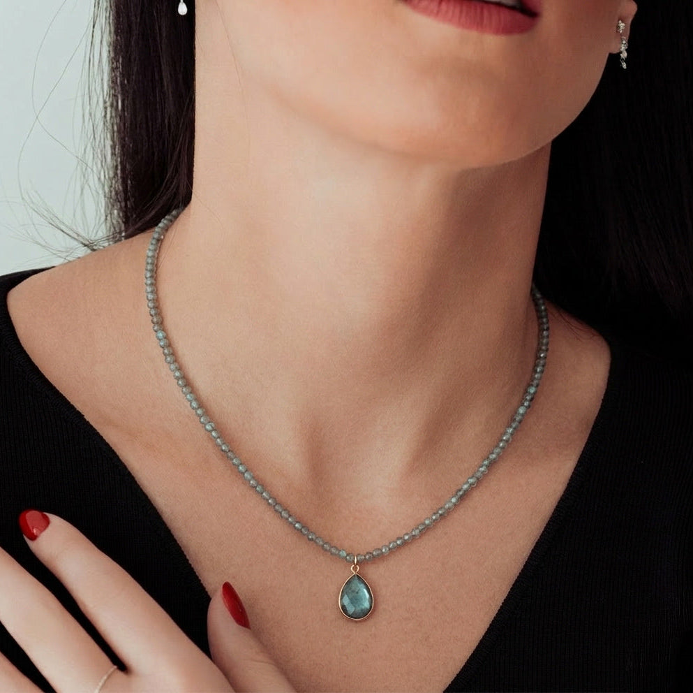 14k yellow gold labradorite gemstone necklace with diamond cut beads and pear drop pendant on model