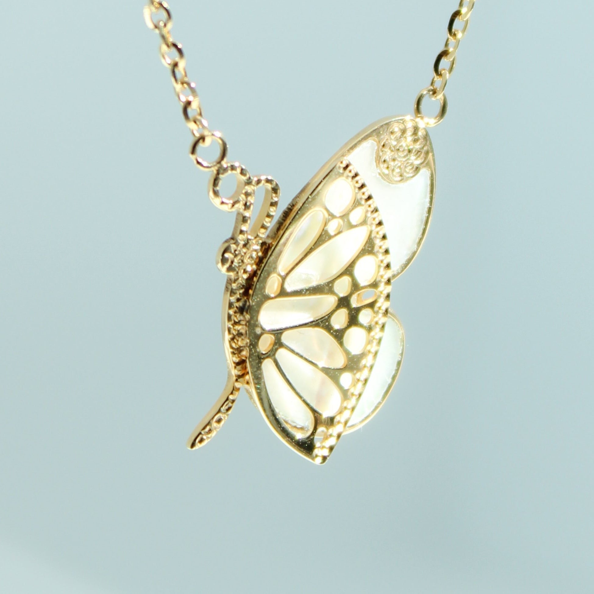 14K solid yellow gold mother-of-pearl butterfly necklace with delicate butterfly details and adjustable chain.