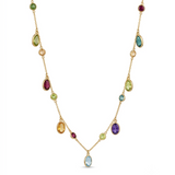 Woman wearing an 18K solid yellow gold multi-gemstone necklace featuring natural garnet, blue topaz, citrine, peridot and amethyst bezel-set charms