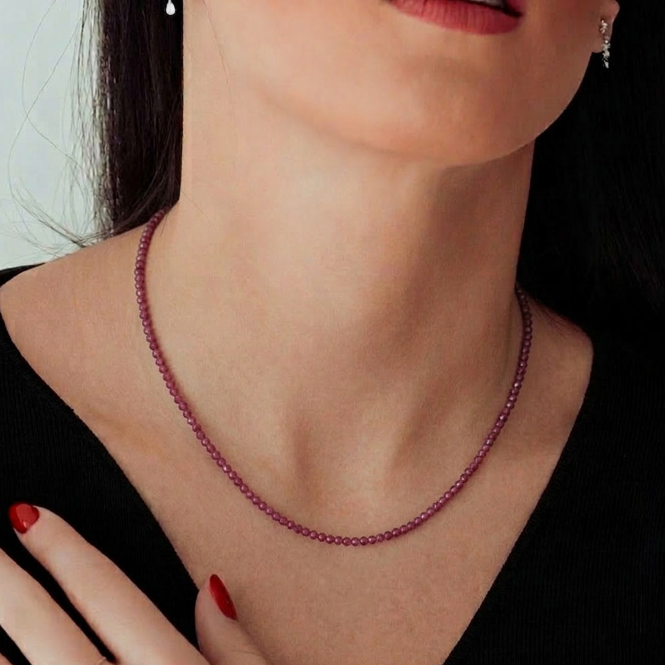 14k yellow gold ruby gemstone bead necklace with diamond cut rubies worn on model