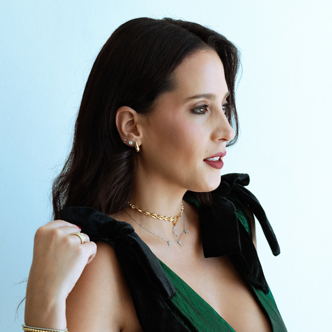 Woman wearing jewelry with a light blue background