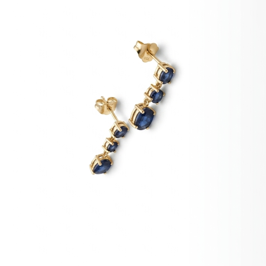 18K yellow gold natural blue sapphire dangle earrings with three sapphire stones in a graduated drop design.
