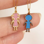 Close-up of custom 14K yellow gold enamel child charm pendants available in personalized colors and engraving options