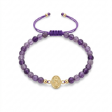 14K solid yellow gold adjustable bracelet with natural amethyst stones, Miraculous Medal center, purple satin macramé cord, and round gold bead end details on white background