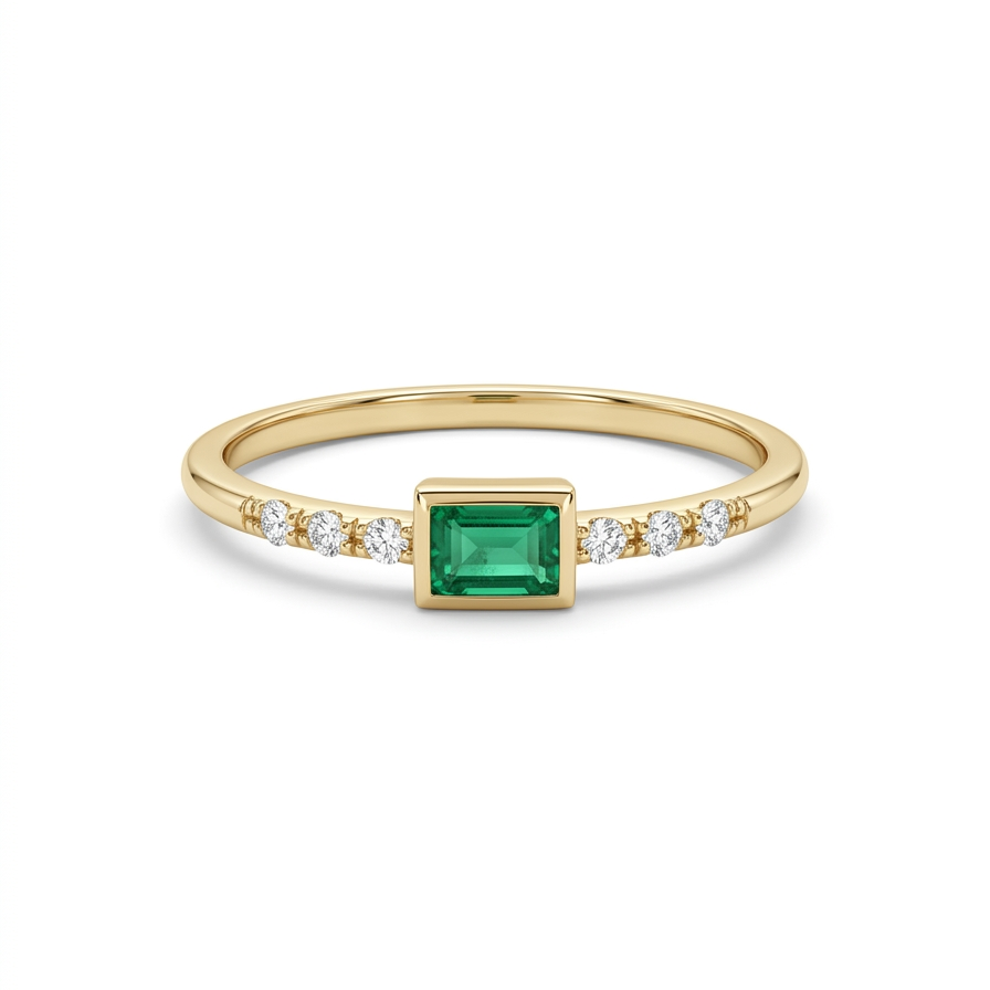     Delicate 14K yellow gold emerald cut green CZ ring with diamond accents held between fingers