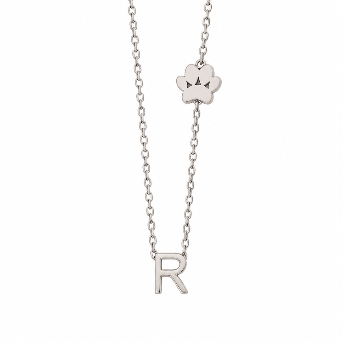 14K solid white gold necklace with an R initial and paw print motif on an 18-inch box chain.