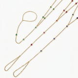 14k gold gemstone hand chain bracelets with emerald ruby and blue sapphire variants on white background