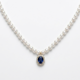 18K solid yellow gold pearl necklace with 118 cultured pearls, an oval blue sapphire centerpiece, and a diamond halo pendant.