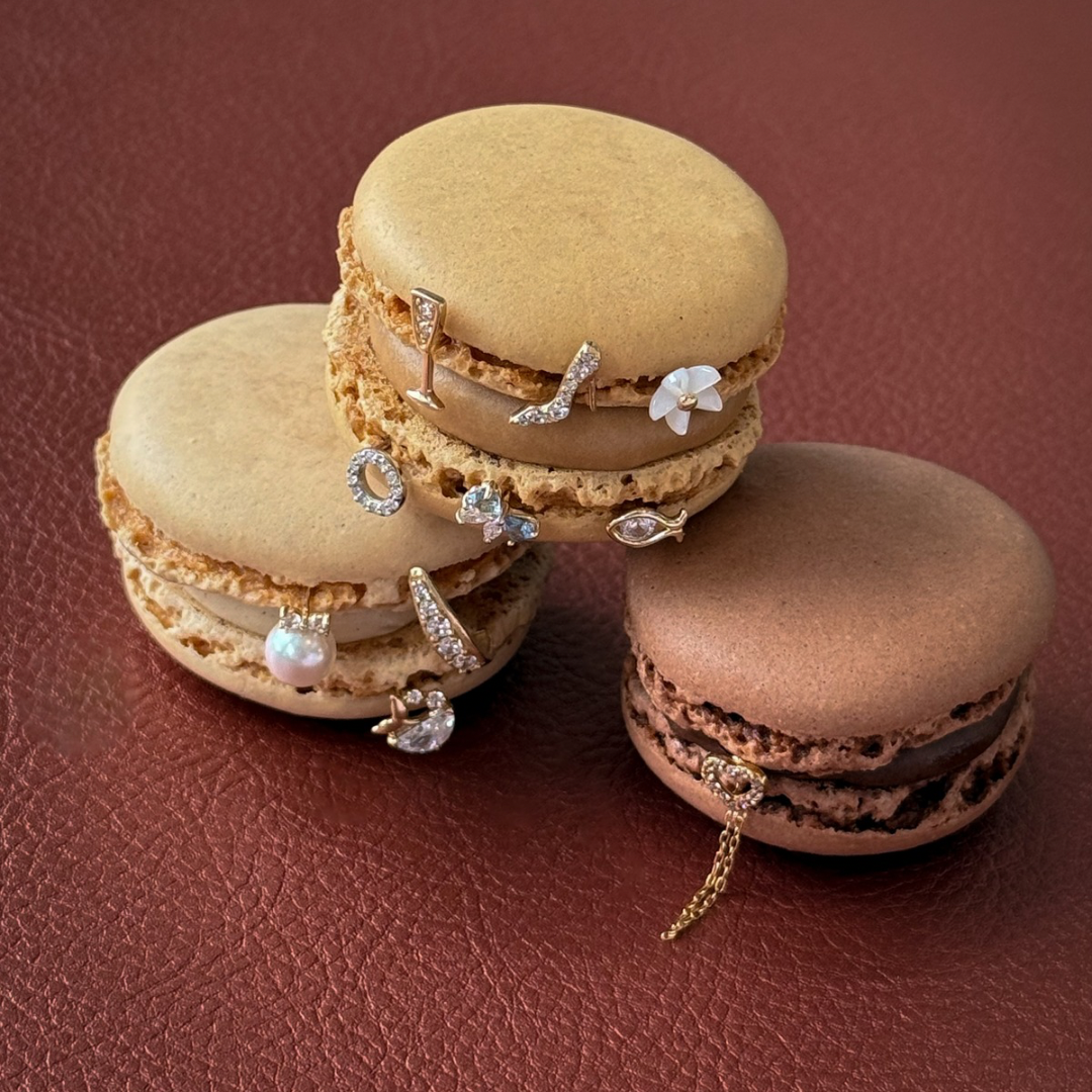 Macarons with jewelry on a brown surface