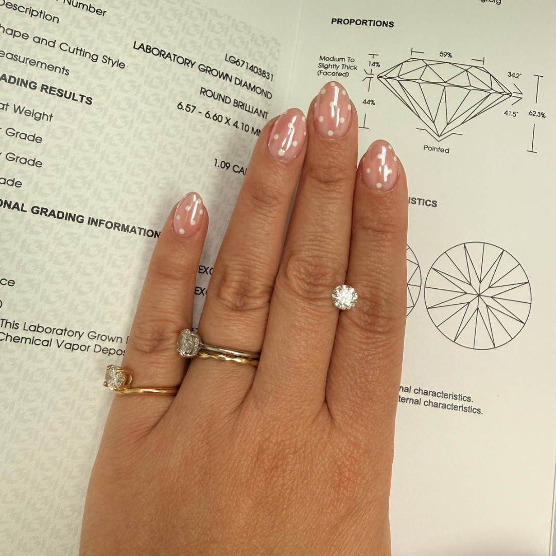 1.09 ct IGI certified lab-grown round brilliant diamond shown on hand with certification report