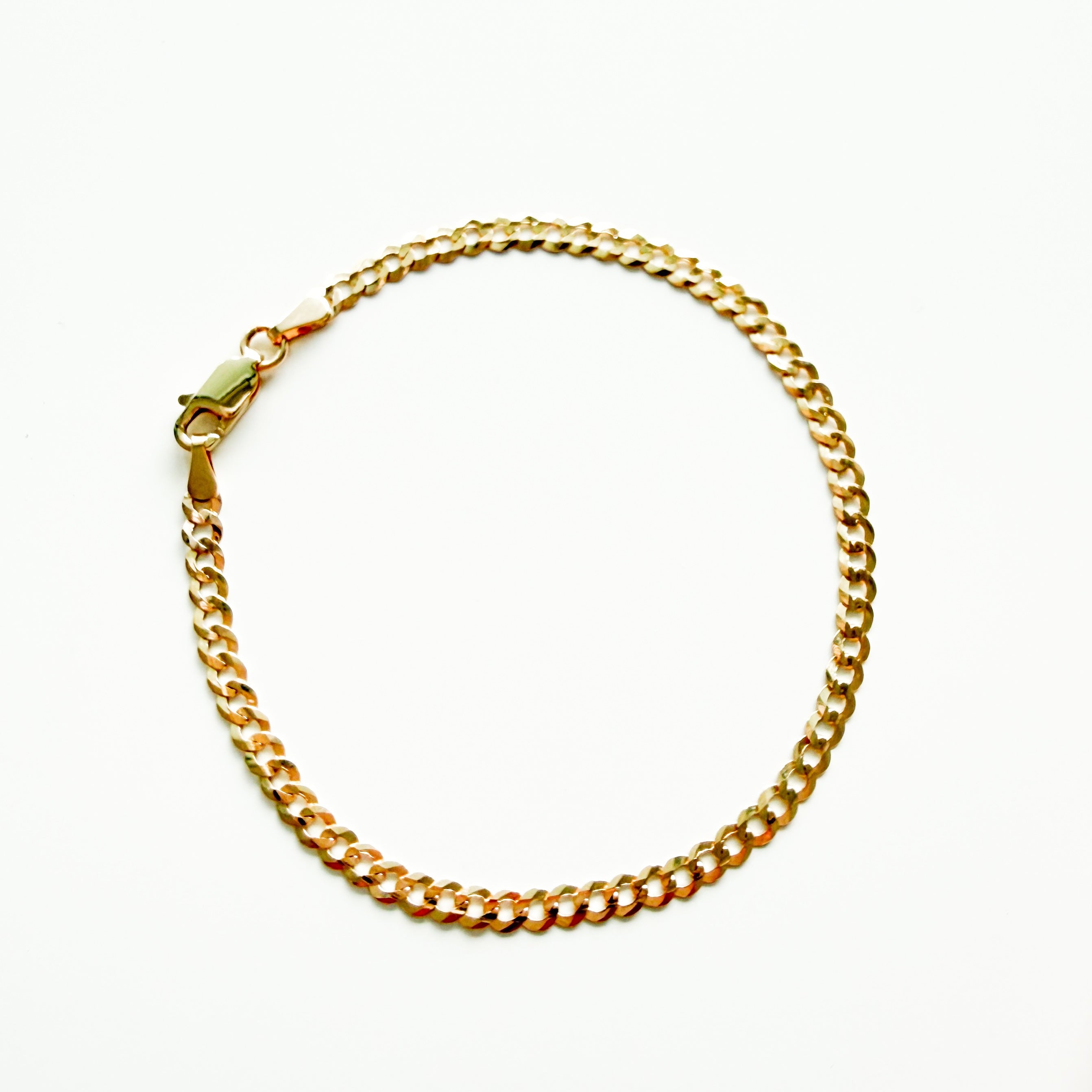 Gold chain bracelet on a white background