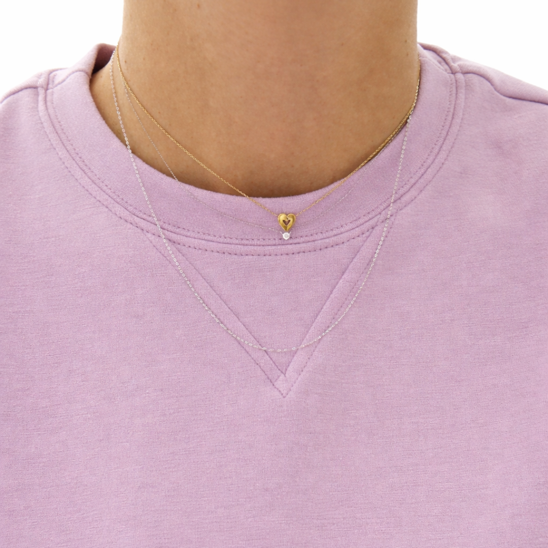 14K solid gold heart necklace with diamond accent layered with fine chain on lavender top