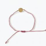 14k yellow gold saint benedict bracelet with pink crystal beads and adjustable pink macrame cord

