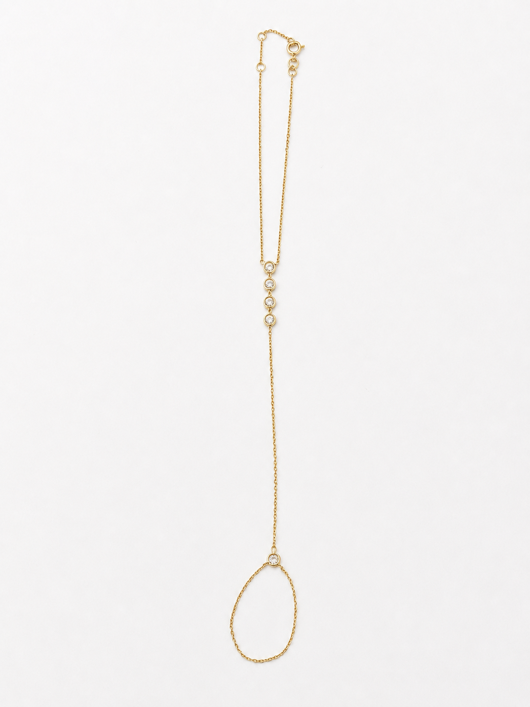14K solid yellow gold hand chain bracelet laid flat, showing the finger ring, connecting chain, five bezel diamonds, and adjustable wrist bracelet.
