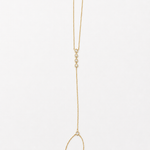 14K solid yellow gold hand chain bracelet laid flat, showing the finger ring, connecting chain, five bezel diamonds, and adjustable wrist bracelet.