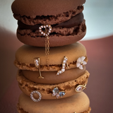 Stack of macarons with various pieces of jewelry on top