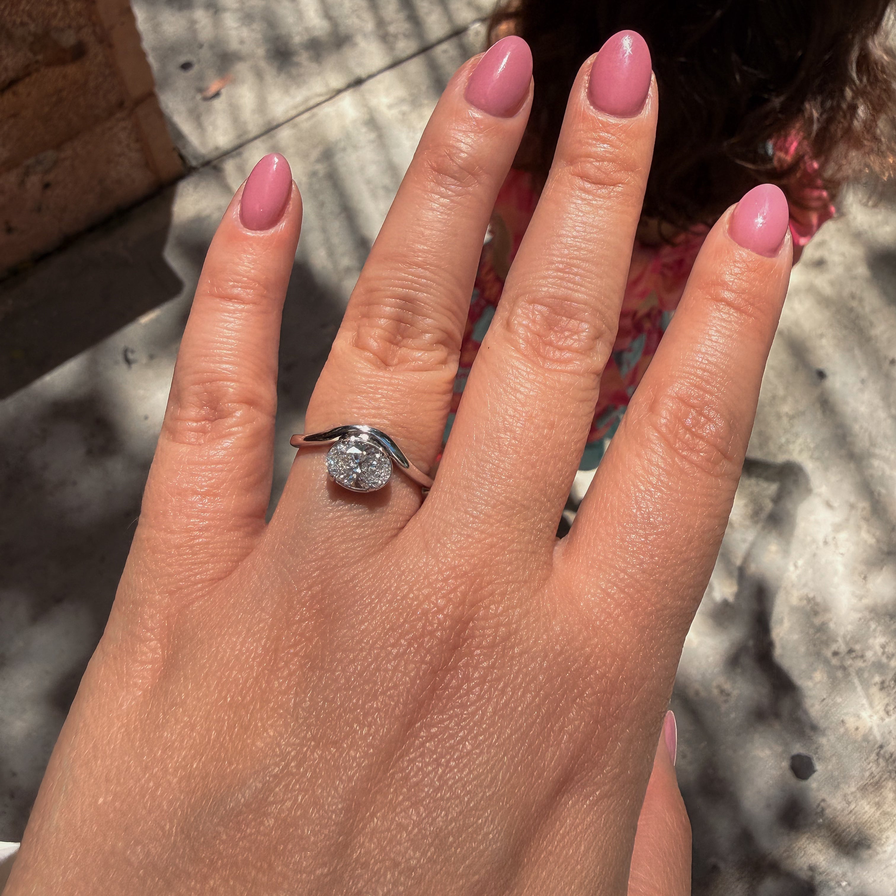 minimalist white gold diamond ring with bezel setting and curved band