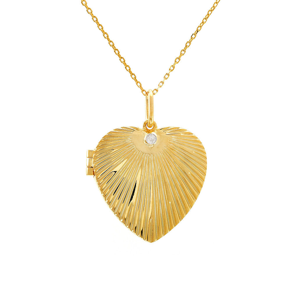 Gold-plated sterling silver heart locket necklace with bezel-set round diamond detail, lifestyle close-up on layered necklaces