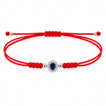 14K solid white gold red silk cord bracelet featuring a natural oval blue sapphire surrounded by pavé diamonds, four polished white gold beads and an adjustable sliding knot closure.