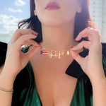 Woman wearing a green dress with black accents outdoors on a sunny day