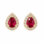Pair of natural pear-shaped ruby stud earrings surrounded by pavé diamond halos in polished 14K solid yellow gold with push-back closures.