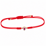14K solid yellow gold red silk cord bracelet featuring a natural pear-shaped ruby surrounded by pavé diamonds, four polished gold beads and an adjustable sliding knot closure.