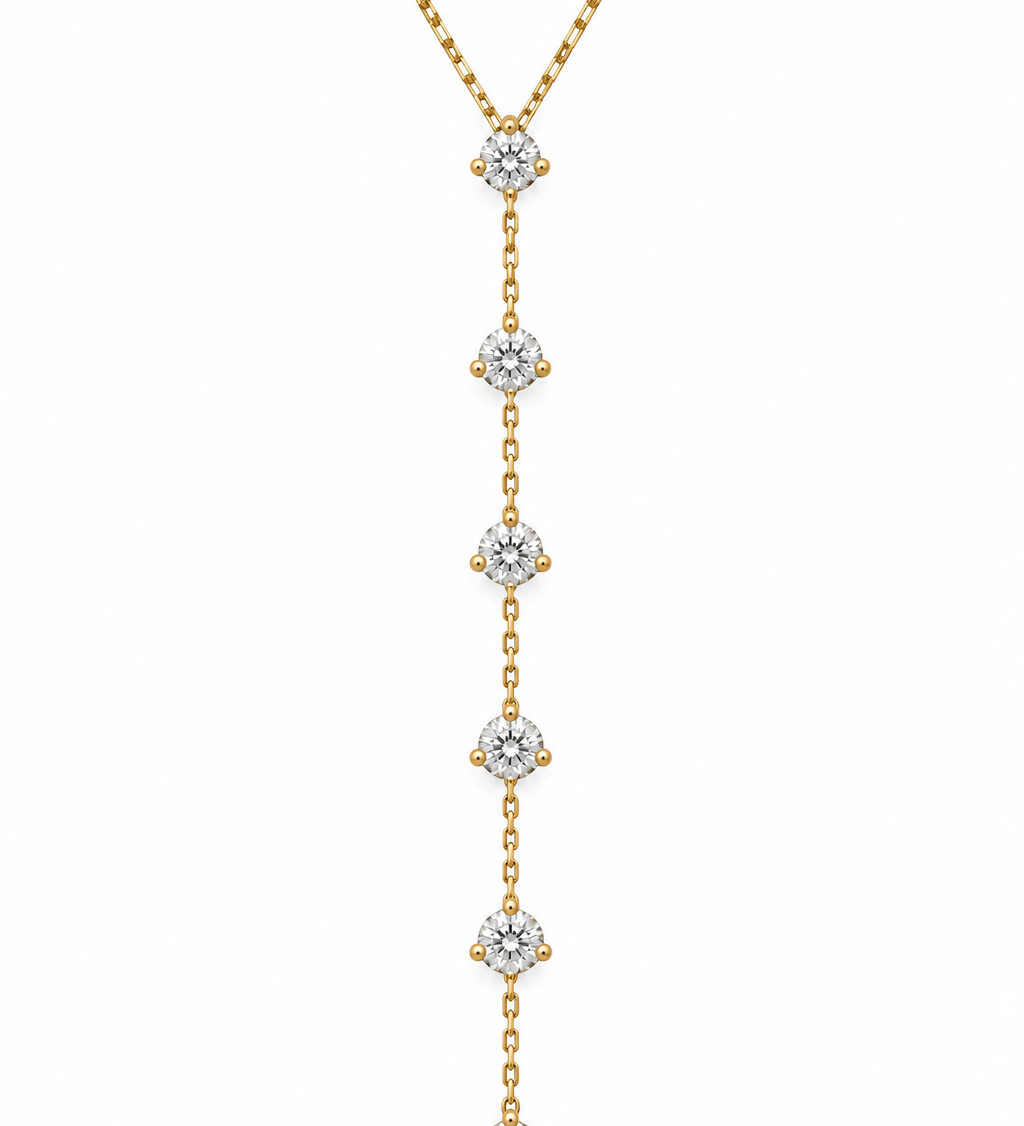 14K solid yellow gold natural diamond lariat necklace featuring seven round diamonds totaling 1.25 carats in three-prong settings with an adjustable box chain.