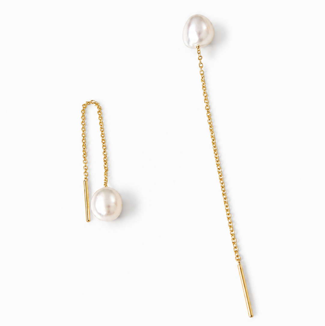 Pair of 14K solid yellow gold threader earrings featuring genuine 7.4 mm freshwater pearls with a delicate 2.75-inch pull-through chain design on a white background.