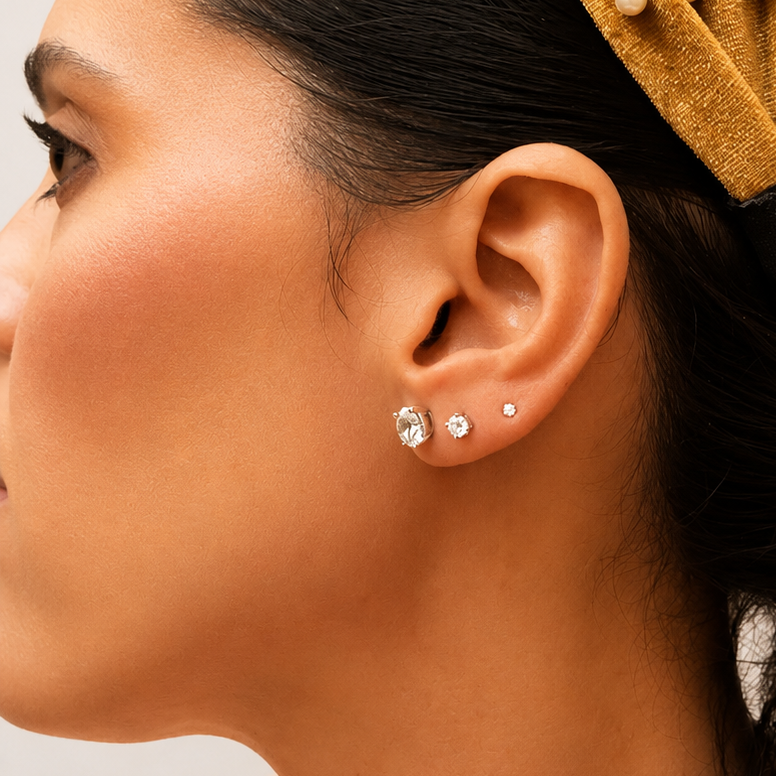 Model wearing 0.32 CT lab-grown diamond stud earrings in solid 14K white gold with D color, VS1 clarity, and secure push-back closures.