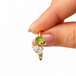 Side view of 14K solid gold custom pear birthstone ring with lab-grown diamond and natural peridot