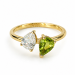 14K solid gold two-stone pear birthstone ring with lab-grown diamond and natural peridot worn on hand