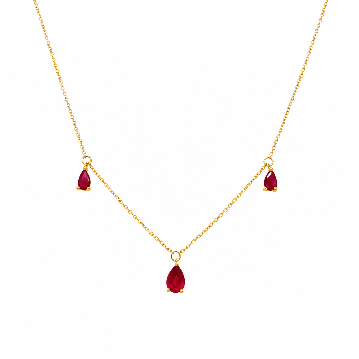 14K yellow gold necklace with three pear-shaped genuine ruby charms on a delicate chain, photographed on a clean white background.