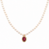 18K solid yellow gold pearl necklace with genuine oval ruby pendant surrounded by a diamond halo on a white background.