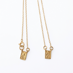 14K solid yellow gold Virgen del Carmen and Sacred Heart scapular necklace with delicate rolo link chain photographed on a white background.