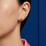 Close-up ear styling featuring 14K solid yellow gold vintage X stud earrings in a textured crisscross design paired with a minimalist gold ball stud for an elegant everyday luxury jewelry look.