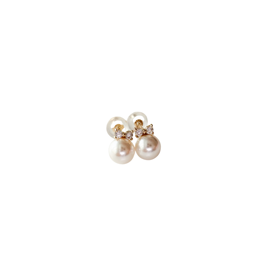 Pair of pearl earrings with gold accents on a white background