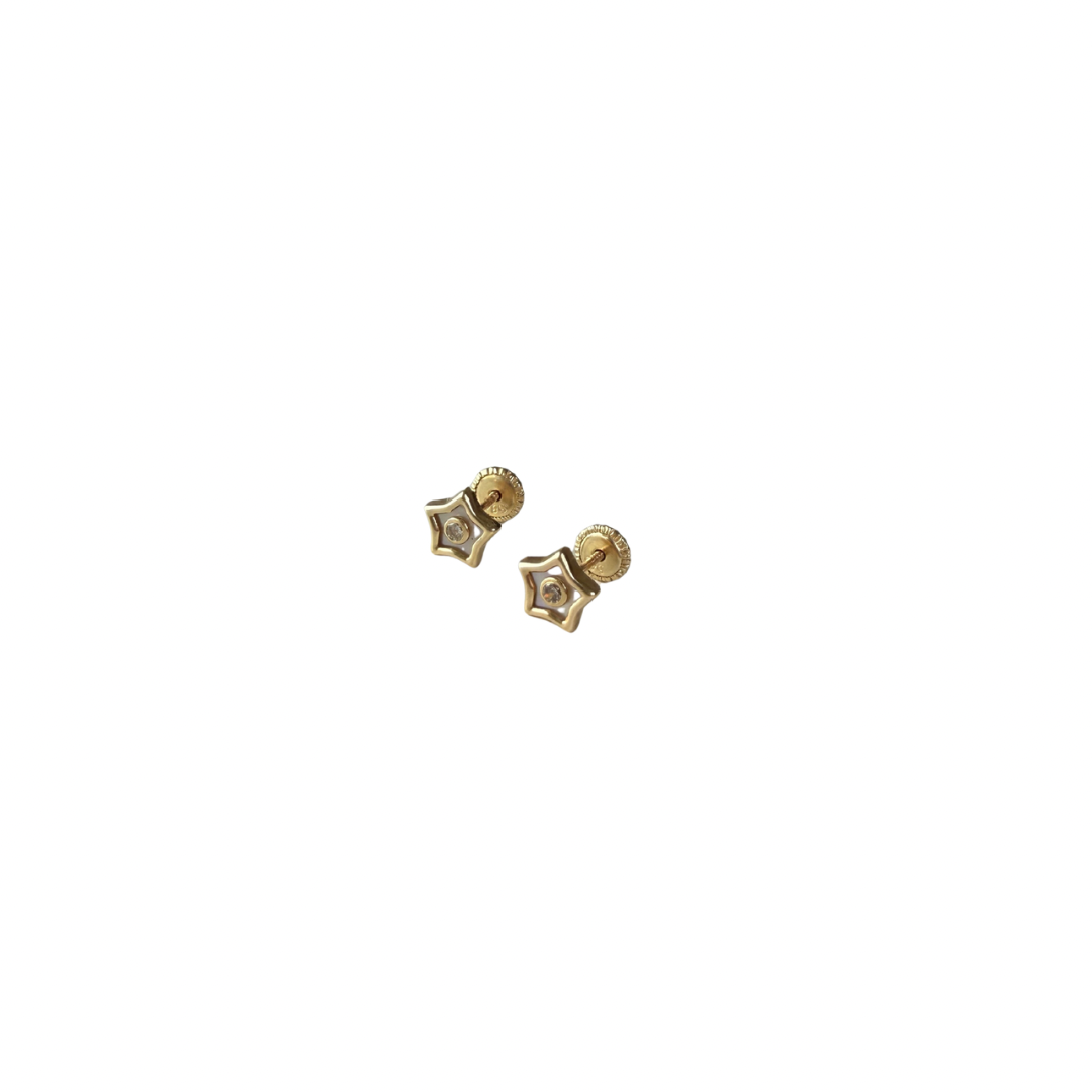 Gold star-shaped earrings on a white background