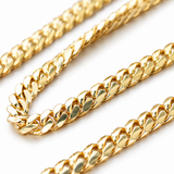 Close-up of a 14K solid yellow gold 6 mm Cuban link chain with polished interlocking links on a white background.