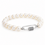White pearl bracelet with a silver-tone carabiner clasp featuring a pavé-set cylindrical closure, photographed on a white background.
