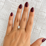 IGI certified 1.07 CT oval lab-grown diamond, E color and VVS2 clarity, displayed on hand for size reference.