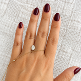 IGI certified 1.07 CT oval lab-grown diamond, E color and VVS2 clarity, displayed on hand for size reference.