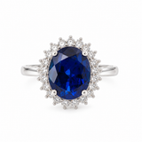 14K white gold ring with 5.63 carat oval lab-grown blue sapphire and lab-grown diamond halo