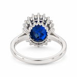 5.63 carat oval mixed cut lab-grown blue sapphire surrounded by 0.45 CTW lab-grown diamonds in 14K white gold