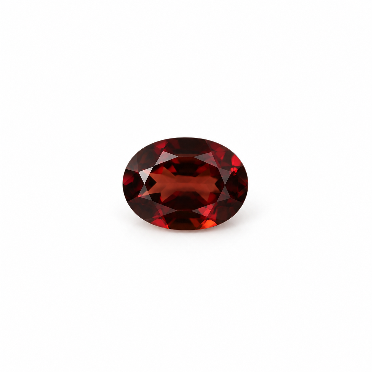 Oval 7 x 5mm garnet loose gemstone with deep red tones on white background