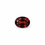 Oval 7 x 5mm garnet loose gemstone with deep red tones on white background