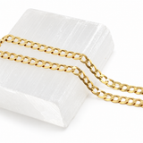 14K solid yellow gold 6mm Cuban link chain displayed on a white background