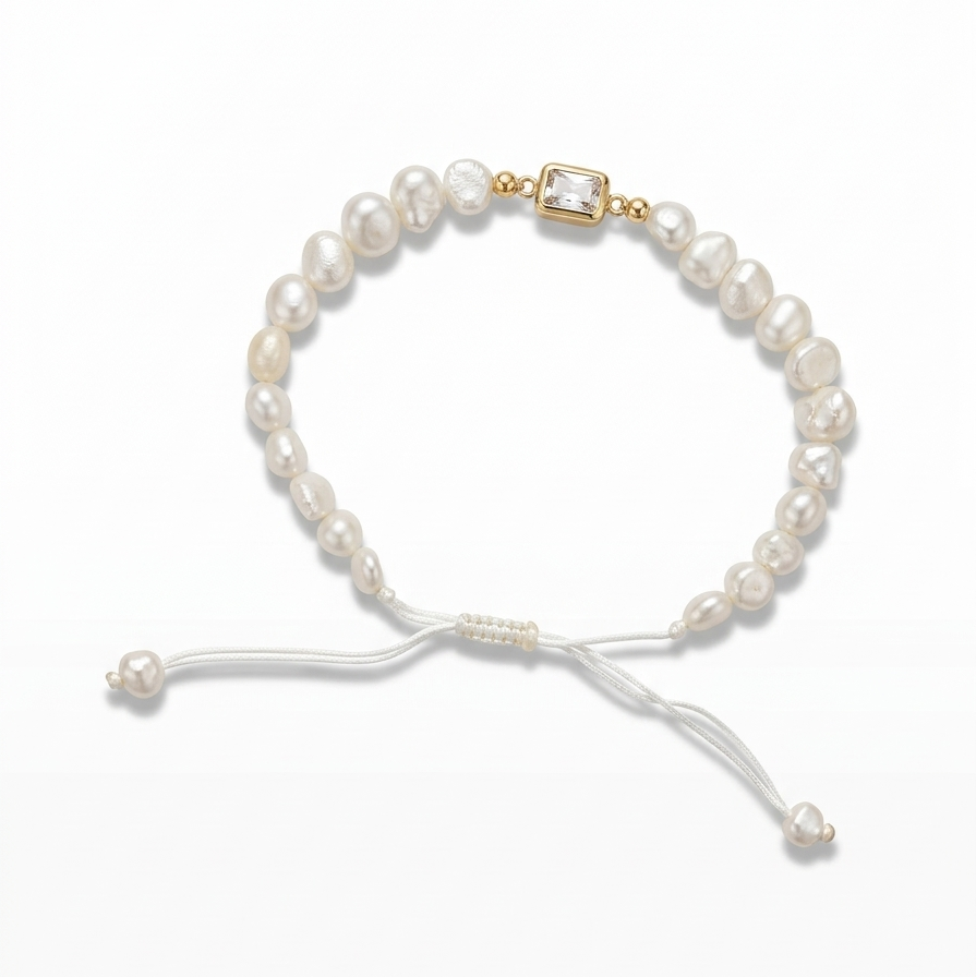 14K solid yellow gold adjustable bracelet with flat freshwater baroque pearls, white satin macramé cord, rectangular bezel cubic zirconia center, and gold end bead detail